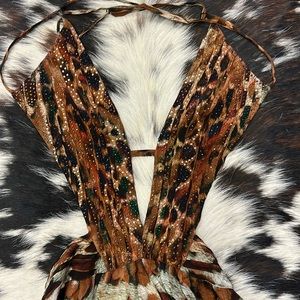 note there is a tear at the bottom off dress.  Very camouflaged by the print